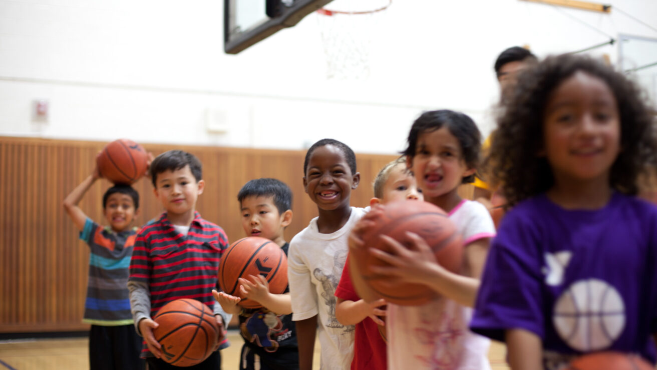 Youths holding basketballs.