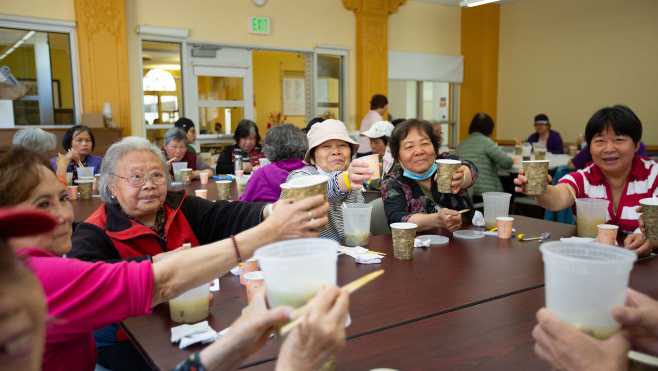 Group of seniors raising their cups in celebration.