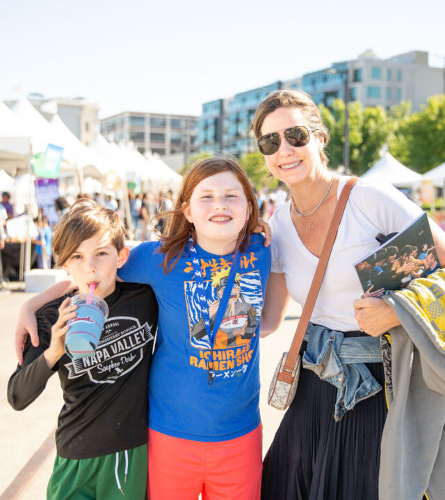 Adult female and two youth posing for photo