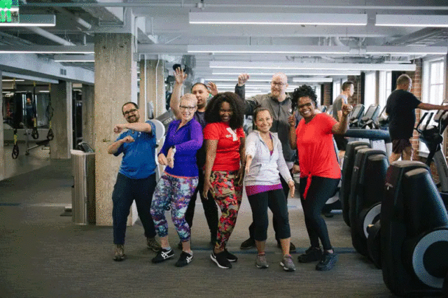 A group of people wearing workout clothing posing for a photo.
