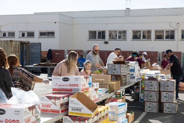 Volunteers packing bags of groceries.