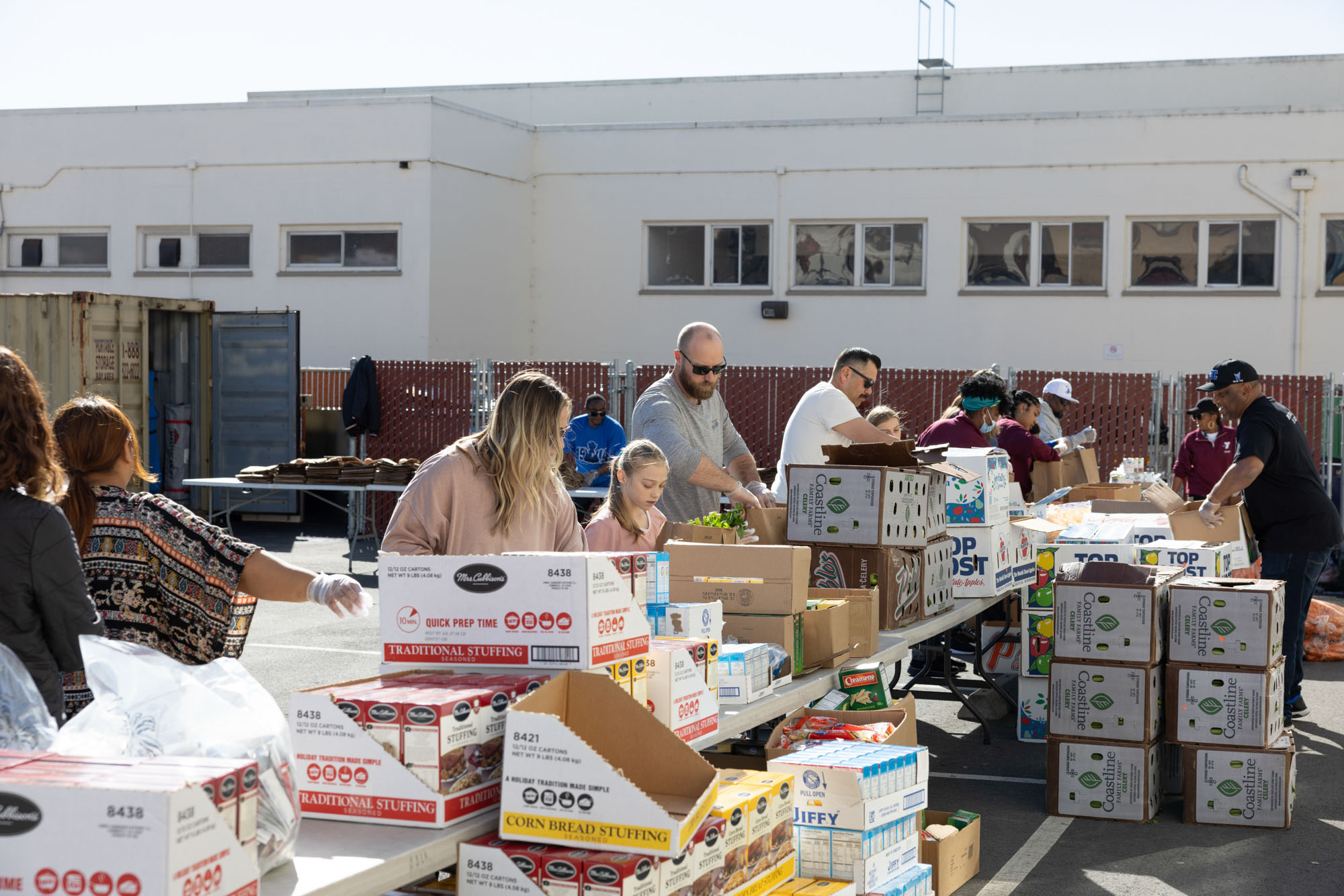 Volunteers packing bags of groceries.