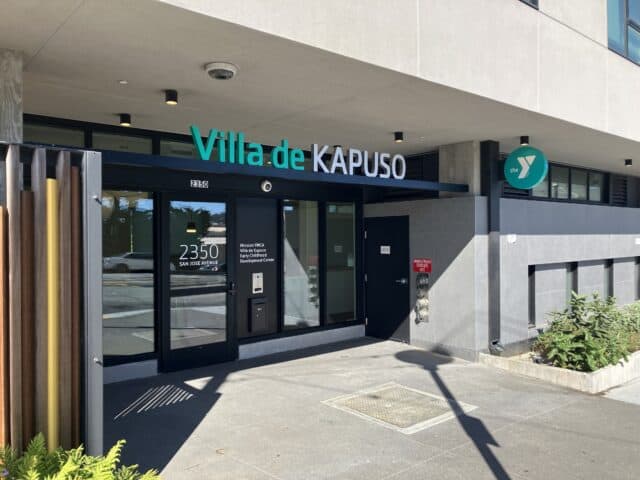 Exterior view of the Villa de Kapuso Child Development Center, showing a modern building with large window, front door entrance, and surrounding sidewalk