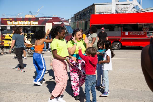 Four youth dancing with two adults.