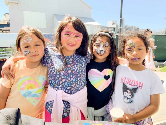A group of four females posing for a photo.