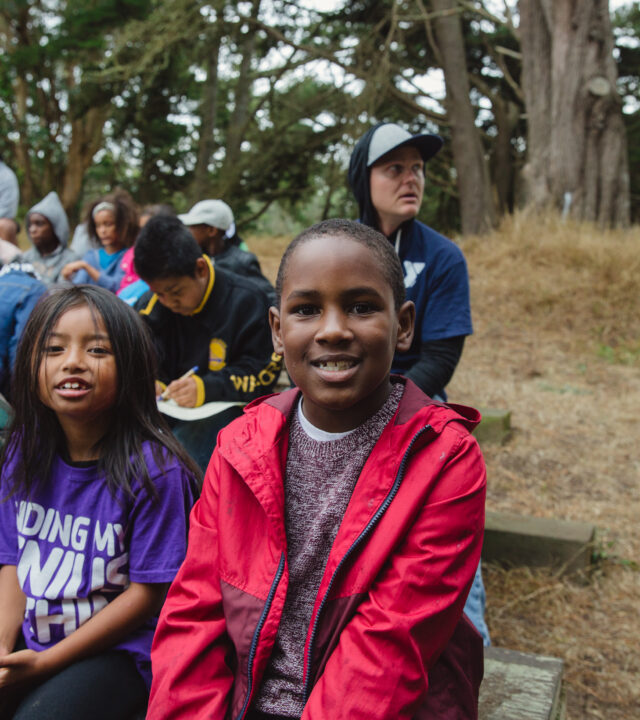 Presidio Community YMCA - Y Rangers Program - A group of elementary-aged youth in an outdoor park.