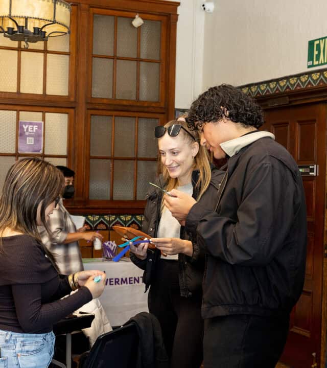 A group of three people having a discussion.