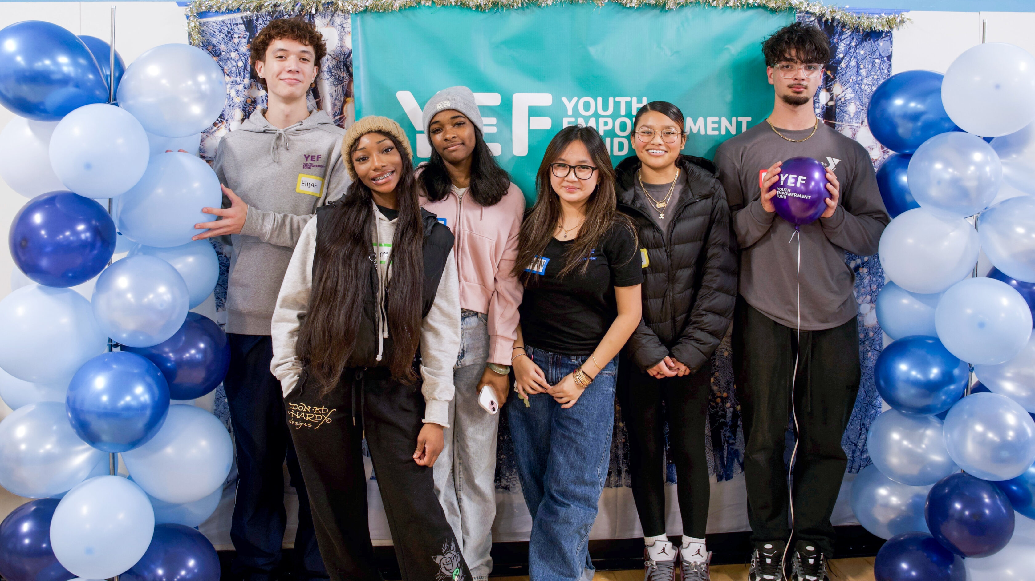 A group of six people posing for a photo.
