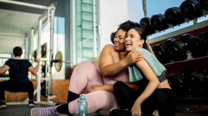Friends women embraced on gym