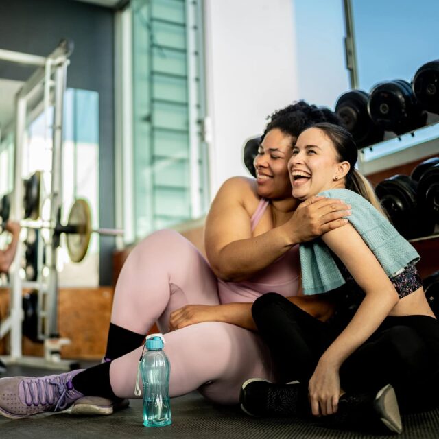 Friends women embraced on gym