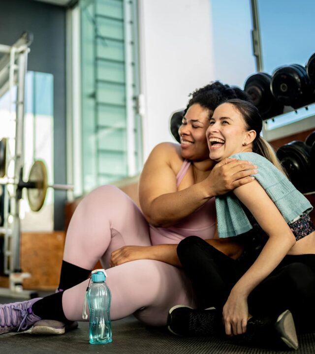 Friends women embraced on gym