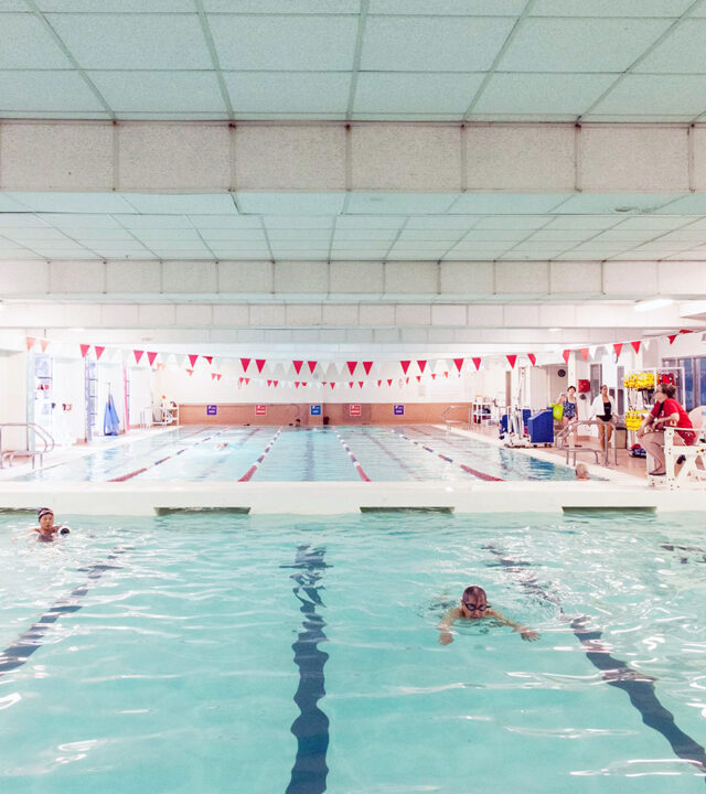 Indoor swimming pool with a swimmer swimming.