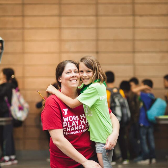 Adult and youth posing for a photo.
