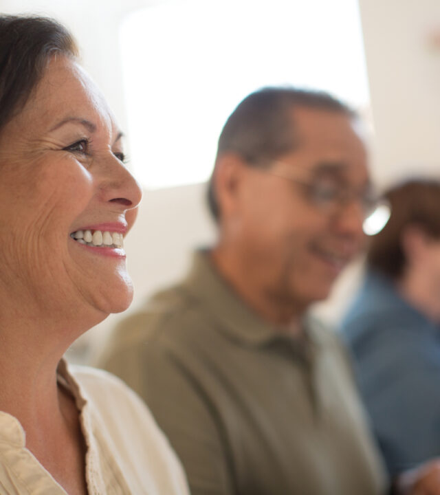 Woman and man smiling taking a class together