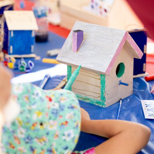 Wooden bird house with pastel colors