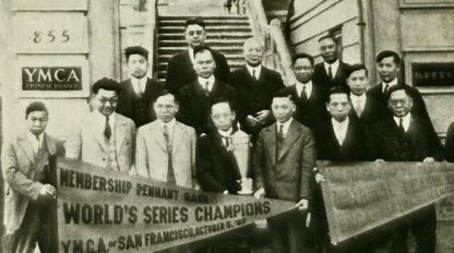 A group of men in suits pose outside a building, holding a trophy and a banner that reads “World’s Series Champions YMCA San Francisco, October 8, 1935,” capturing a proud moment in time that echoes the legacy celebrated in Five YMCA Anniversaries Tell Story of San Francisco’s Community History.